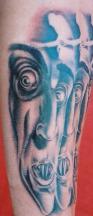 Devil faces tattoo in blue with big eyes.JPG