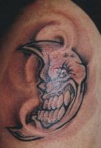 Evil moon tattoo