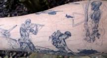 Soldiers in war tattoo.JPG