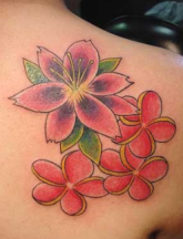 Female tattoo with hawaiian flowers.PNG