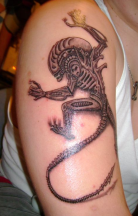 Scary alien tattoo on the arm.PNG