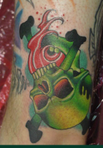 Bright green skull upside down tattoo.PNG