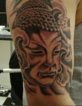 Big Buddhist Face Tattoo on the arm.PNG