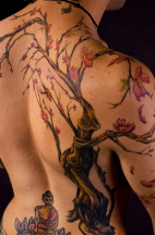 Buddhist prayer tattoo with flowers on full back.PNG