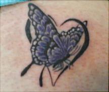 Dark blue butterfly tattoo with a heart