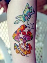 Greenish butterfly with mushroom tattoo