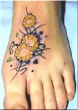 yellow flowers on foot tattoo