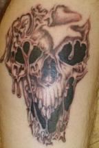melting evil skull tattoo