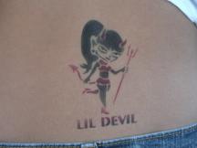 female devil tattoo on lower back.jpg