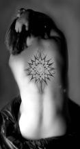 sun tattoo in the back.jpg