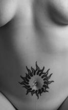 Big sun tattoo on belly.jpg