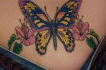colorful butterflly tattoo with pink flowers and leaves
