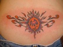 sun tattoo on the lower back