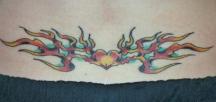 image of lower back tatto with fire and heart