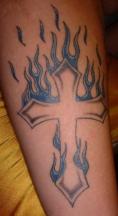 White cross on fire tattoo