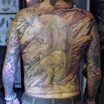 whole back tattoo with a wolf.jpg