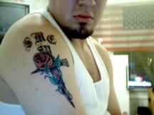 Rose on cross tattoo