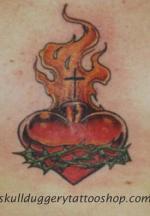 Heart on fire with cross tattoo